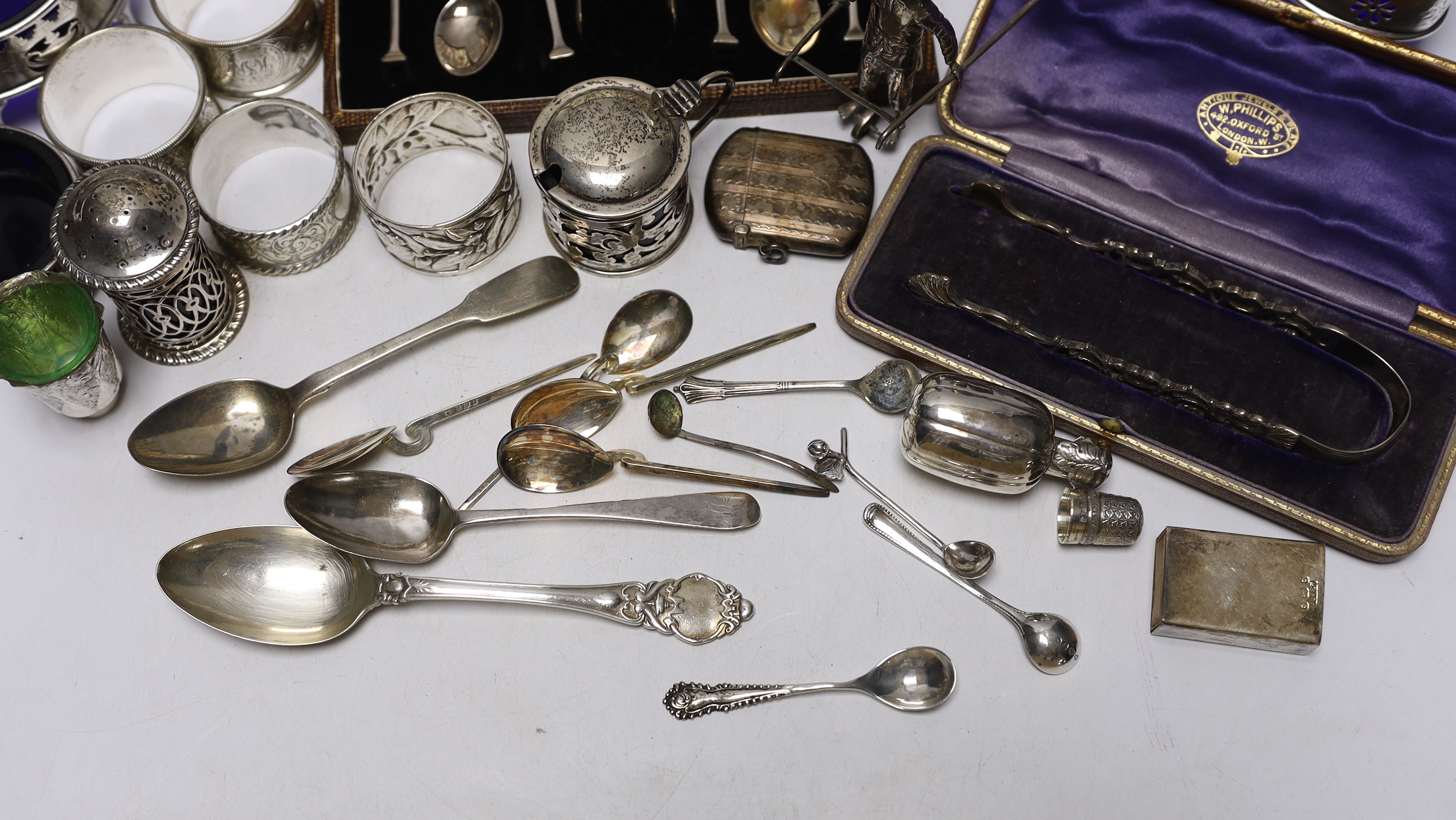 A collection of small silver to include a christening cup, a pair of late Victorian navette shaped salts, a Chinese white metal cruet (incomplete), flatware including cased teaspoons, vest case, napkin rings, etc.